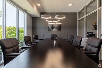 a conference room with a long table and chairs